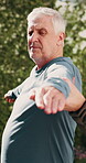 Senior, man and warrior pose with trainer outdoor, exercise and wellness with stretching for posture. Male person, coach and help with advice for yoga, fitness and balance with support in nature