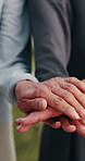 Outdoor, people and hands together with personal trainer for fitness, support and health celebration. Nature, teamwork and huddle with stack for solidarity, exercise goal or motivation for wellness