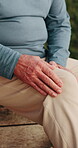 Senior, person and hands with knee pain for joint inflammation, discomfort or arthritis in home. Elderly, leg or injury with sore ache, massage or strain for fibromyalgia or muscle tension in house
