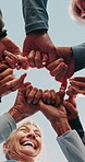 Blue sky, people and hands together with circle for fitness, support and health celebration. Nature, teamwork and personal trainer with huddle for solidarity, exercise goal or motivation in low angle