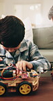 Son, dad and high five with toy car for engineering or remote control vehicle in home together. Boy, child or learning with father or success for robotic build for junior mechanic or development