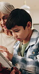 Smile, grandma and child at house with tablet, browsing and download ebook for education. Happy, senior woman and kid in lounge with digital, watching video and educational games for online learning