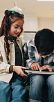 Children, tablet and playing together on home sofa with internet connection, education or gaming app. Boy, girl and technology with siblings or family while happy, learning and sharing in house