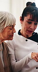 Senior woman, listen and caregiver with tablet in house, consultation and explain medical diagnosis. Retirement, home and nurse with tech, talking and healthcare information on web for elderly person