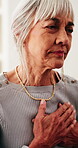 Sick, tired and old woman in home with chest pain, stress or heart attack symptoms for medical issue. Elderly person, health crisis and emergency in house with cardiac arrest, discomfort and fatigue.