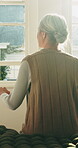 Thinking, back or old woman in house with walking stick, daydreaming or nostalgia in calm mindset. Reflection, window or senior person with disability, flashback or peaceful perspective in retirement