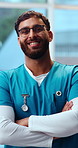 Face, nurse and happy man in hospital with arms crossed, laugh and funny joke for medical residency. Confident, male person and healthcare worker in clinic with smile, internship or humor for career.
