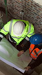 Engineering, people and discussion on construction site with blueprint, partnership or building project. Above, engineer team and talk with floor plan, layout document and advice for infrastructure.