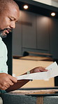 Black man, document and laptop with remote work for remodel, architecture vision or floorplan review. Thinking, mature person WFH or home renovation with paperwork for planning, typing and technology