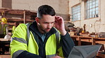 Carpentry, headache and man in warehouse with laptop, brain fog and blueprint mistake in building plan. Burnout, tech and artisan with migraine pressure, discomfort and fatigue in design error.