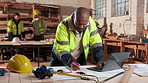 Architect, man and writing with blueprint on laptop in workshop for building project or structure. Male person, computer or checking floor layout for construction design, safety or security on site