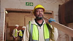 Carpenter, walk and man with timber in workshop, manufacturing and material for furniture production. Woodworking, artisan and mature person with lumber, serious and plank for project and flare