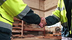 Meeting, shaking hands and people with welcome in woodwork warehouse for building or planning. Manufacturing, factory team and men with handshake for workshop, safety and compliance or maintenance