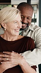 Love, support or interracial couple in house with laugh, partner hug or bonding together in marriage. Smile, caring or mature people with humor, romantic moment or commitment in happy relationship.