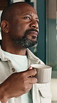 Thinking, coffee and window with black man in home for daydreaming, vision or ambition. Thoughtful, male person or contemplating with drink, reflection or caffeine for morning or past memory in house