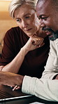 Mature, couple and talk in home with laptop, online website or research together for insurance premium. People, interracial marriage and discussion in house with computer, review policy cover or plan