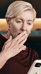 Mature, woman and shock with phone in home for gossip, online news or social media post. Surprise, female person or reading with smartphone for mobile conversation, communication or chat in house