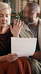 Frustrated, couple or finance with documents in home for over budget, tax inflation or debt. Interracial relationship, man and woman with conflict, fight or disagreement for financial stress in house