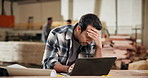 Stress, man and carpenter in workshop with laptop for order cancellation, mistake or negative review. Upset, computer and woodworker with email for error feedback on timber manufacturing project.