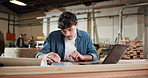 Man, tablet and carpenter in workshop with laptop for research on furniture manufacturing. Computer, technology and woodworker with email for order confirmation with contact at industry warehouse.
