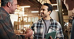 Men, handshake or carpentry team in warehouse with support, tech or happy for project development. Cooperation, people or shaking hands in lumber factory for collaboration, task productivity or unity