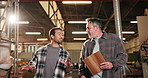Carpentry, clipboard and conversation with men in warehouse together for manufacturing. Collaboration, discussion and tablet with people walking in woodworking plant for agenda, planning or schedule