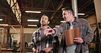 Carpentry, clipboard and pointing with men in warehouse together for discussion or update. Collaboration, management and stock with people talking in woodworking factory for inventory report