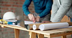 Hands, laptop and drawing on construction site for blueprint, inspection or architect team planning. Infrastructure, quality control and people with tech, meeting or project management for renovation