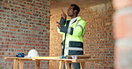 Construction site, radio and black man with engineering, work coordination and development feedback. Communication, architect and person with building inspection, safety compliance and talking