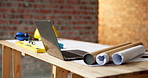 Architecture, laptop and blueprint at empty site for building, maintenance or property development. Computer, floor plan and equipment on desk by construction design for repairs or renovation.