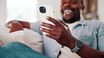 Man, hand and laugh in home with phone, funny online news and meme for social media notification. Happy, black person and browsing on sofa with tech, internet connection and joke from text message.