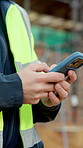 Cellphone, man and hands of construction worker on site with email for approval on infrastructure. Phone, typing and civil engineer on mobile app for feedback on building, maintenance or repairs.