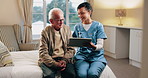 Caregiver, talk and old man in retirement home with tablet, support or happy for medical test results. Nurse, smile and senior person in bedroom with tech, healthcare report or rehabilitation update.