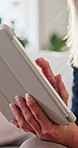 Hands, online and chat with tablet in lounge, scroll and communication with contact on social media. Typing, message and elderly person with technology, internet connection and texting in house