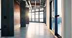 Workspace, building and windows with exterior design in hallway of industrial architecture. Empty, construction or structure with lens flare, interior, corridor for passage or view in modern office