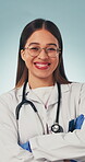 Doctor, face and happy with arms crossed in health for medical service, career integrity or trust. Worker, woman and laugh on studio background for healthcare support, cardiology expertise and pride