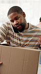 Phone call, box and black man in new home with communication, networking or confirmation of property. Cardboard parcel, cellphone and person on mobile discussion for moving with real estate agreement