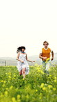 Holiday, running and couple in field with fun, outdoor bonding and happy moment on trip. Laugh, space and people with vacation, romantic relationship and playful connection on countryside getaway.