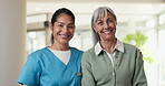 Face, caregiver and old woman at house with smile, support and medical trust for wellness. Portrait, nurse or senior person in home with embrace, assisted living and gratitude for healthcare services