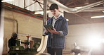 Man, carpenter and reading at workshop with tablet, research and inventory for timber production. Male person, review and tech at factory for carpentry, supplier approval and manufacturing furniture