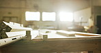 Planks, warehouse and wood with equipment for carpentry, furniture restoration and lumber manufacturing. Flare, factory and timber with gear for woodwork project, production and industrial business