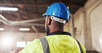 Back, man and carpenter in workshop with hardhat, compliance and timber production. Male person, helmet and supervisor in factory for carpentry, quality assurance and ppe for manufacturing furniture
