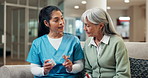 Caregiver, advice and old woman in clinic with pills, medical instructions or discussion for health. Senior person, nurse and talk in hospital with medicine, prescription or recommendation for drugs.