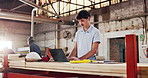 Man, carpenter and typing in workshop with laptop, research and review design for production. Person, reading and pc in factory for carpentry, online blueprint and policy for manufacturing furniture