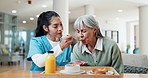 Caregiver, feeding and old woman at house with food, support and breakfast for nutrition diet. Nurse, helping and senior person in lounge with meal, assisted living and morning brunch for wellness