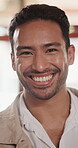 Wellness, face and man in cafe with laugh, positive attitude and happy moment on weekend break. Wellbeing, portrait and person in restaurant with good mood, confidence and satisfaction with day off.