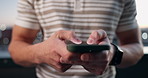 Hands, phone and typing with person outdoor for communication, networking and travel update. Mobile, man and chat app for text message, internet connection or online guide for tourism on city rooftop