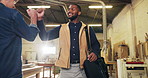 Carpentry, fist bump and walking with man arriving in warehouse for work in furniture business. Greeting, smile and wave at colleague with happy person in woodworking plant for creative or design job