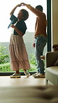 Happy, couple and spin in home with dance, embrace and connection for bonding together on weekend. Married, black people and hug in living room with love, romantic relationship and rhythm to music.