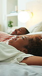 Couple, sleep and happy on bed, home and relax together on break and jump with partner in apartment. Black people, smile and comfortable on mattress, stress relief and resting with spouse in bedroom